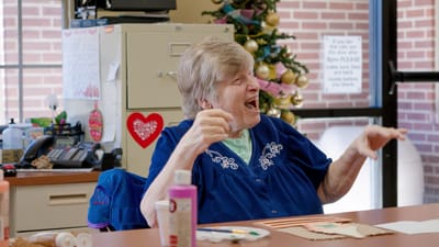 Timberlane Health & Rehab, assisted living in El Dorado, AR — Elderly woman laughing in a colorful activity room