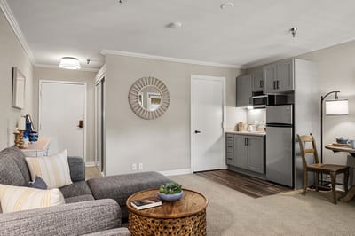 A cozy interior view of a resident unit with a kitchenette