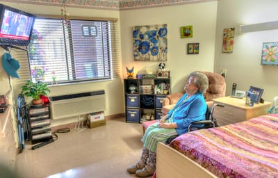 Resident enjoying a television in their private room