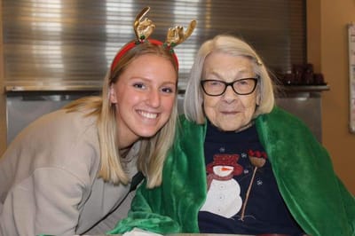 A resident and staff member smiling during a holiday celebration