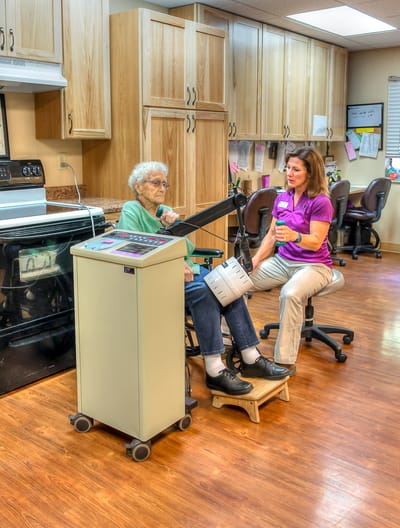 Staff assisting a resident in a care facility setting