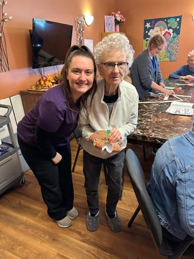 A staff member and resident during an activity