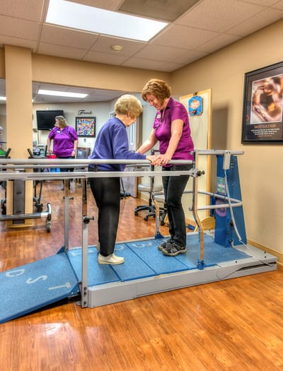Physical therapy session with a resident and staff member