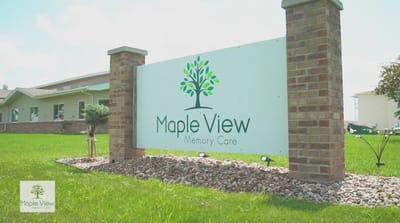 Sign for Maple View Memory Care with green tree logo