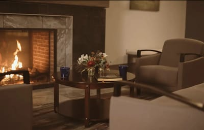 Cozy common area with fireplace and floral arrangement