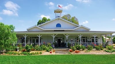Exterior view of a nursing home building with gardens