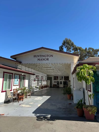 Entrance of Huntington Manor with sunny sky