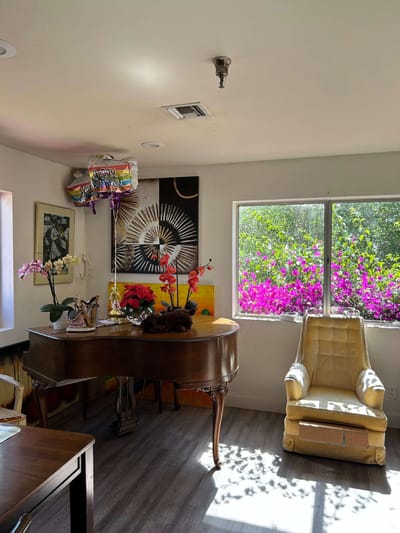 Brightly decorated common area with flowers and furniture