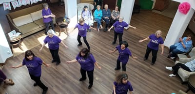 Residents participating in a dance activity in a common area