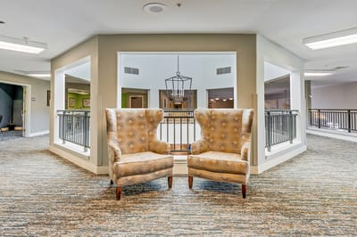 Common area with two armchairs and balcony view