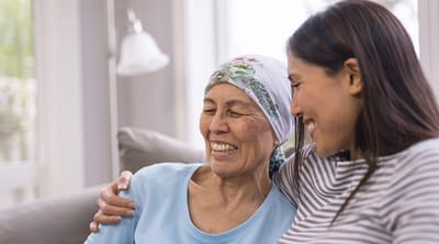 A caregiver and a resident sharing a joyful moment