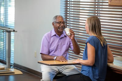 Good Samaritan Society – Mohall, Nursing Home in Mohall, ND — Two people engaged in conversation over drinks