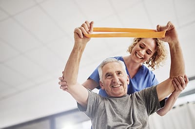 Good Samaritan Society – Mohall, Nursing Home in Mohall, ND — Senior resident engaging in physical therapy with staff support
