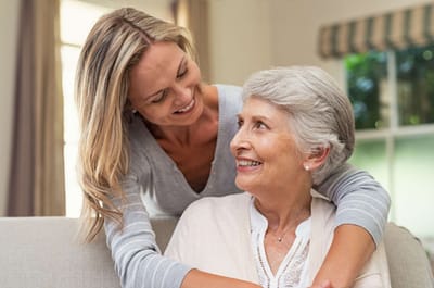 Good Samaritan Society – Mohall, Nursing Home in Mohall, ND — Smiling woman embracing her elderly mother at home