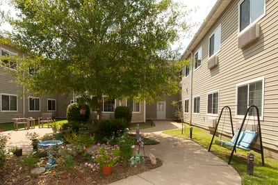 Outdoor courtyard with seating and flower beds