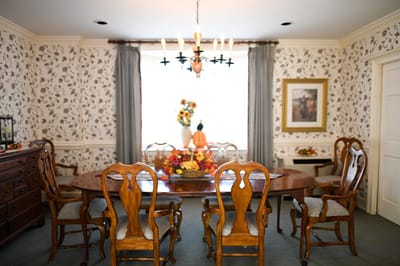 The Inn at Fairview, nursing home in Hudson, NH — Elegant dining room with floral wallpaper and chandelier