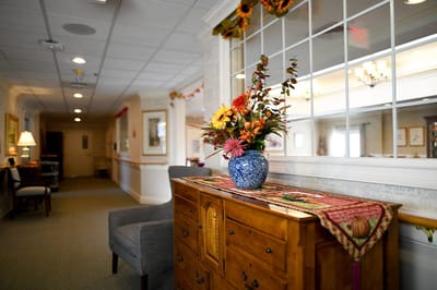 The Inn at Fairview, nursing home in Hudson, NH — Decorative vase with flowers on a wooden side table