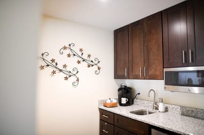 The Inn at Fairview, nursing home in Hudson, NH — Modern kitchenette with decorative wall accents