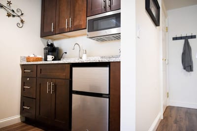 The Inn at Fairview, nursing home in Hudson, NH — Compact kitchenette with modern appliances and cabinetry