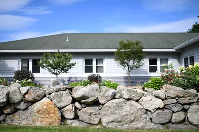 Exterior view of assisted living facility with garden
