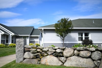Outdoor view of a building with stone wall and garden