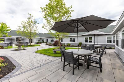 Beautiful outdoor seating area with umbrellas and landscaped gardens