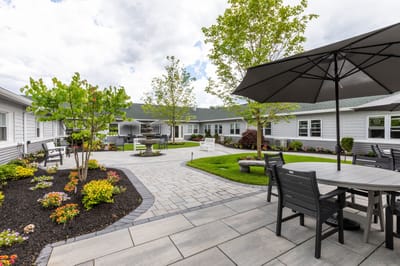 Outdoor patio area with gardens and seating