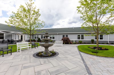 Serene outdoor garden with a fountain and seating