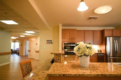The Inn at Fairview, nursing home in Hudson, NH — Granite countertop with a vase of flowers