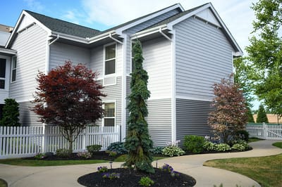 The Inn at Fairview, nursing home in Hudson, NH — Garden area with landscaped bushes and walking paths