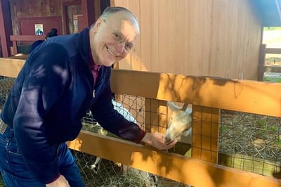 The Inn at Fairview, nursing home in Hudson, NH — Senior resident feeding a goat at a petting farm