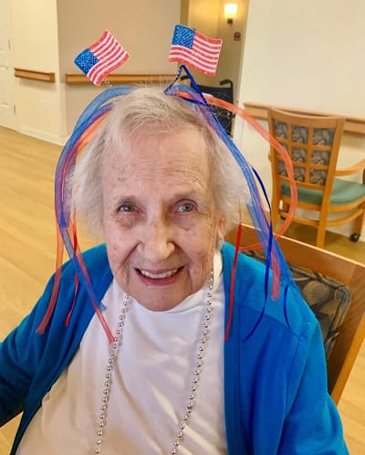 The Inn at Fairview, nursing home in Hudson, NH — Senior resident wearing festive patriotic headband decorations