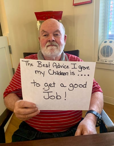 The Inn at Fairview, nursing home in Hudson, NH — Senior resident holding a sign with advice