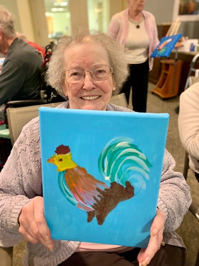 The Inn at Fairview, nursing home in Hudson, NH — Senior resident proudly holding a painted rooster