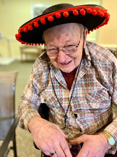 The Inn at Fairview, nursing home in Hudson, NH — Elderly man wearing a sombrero and smiling
