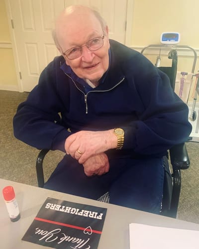 The Inn at Fairview, nursing home in Hudson, NH — An older man sitting at a table with crafts