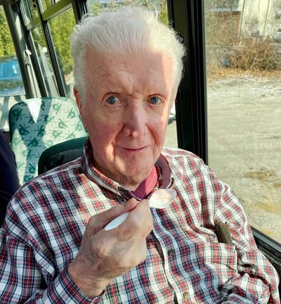 The Inn at Fairview, nursing home in Hudson, NH — Senior man enjoying dessert on a bus