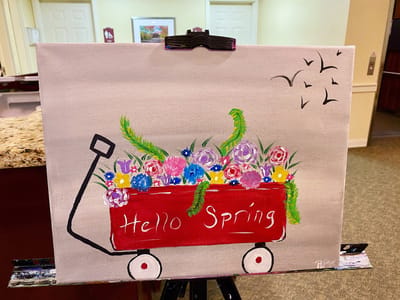 The Inn at Fairview, nursing home in Hudson, NH — Colorful painting of a red wagon filled with flowers