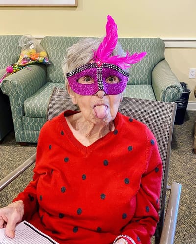 The Inn at Fairview, nursing home in Hudson, NH — Senior resident wearing a colorful mask and playful expression