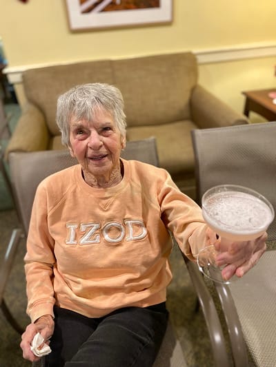 The Inn at Fairview, nursing home in Hudson, NH — Senior resident enjoying a drink in a lounge area