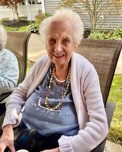The Inn at Fairview, nursing home in Hudson, NH — Smiling elderly woman wearing a necklace and cardigan