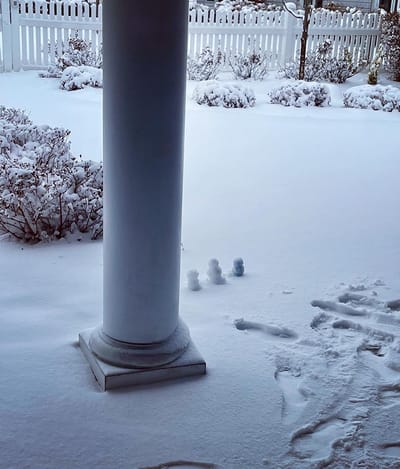 The Inn at Fairview, nursing home in Hudson, NH — Snow-covered landscape with small snowmen near a column