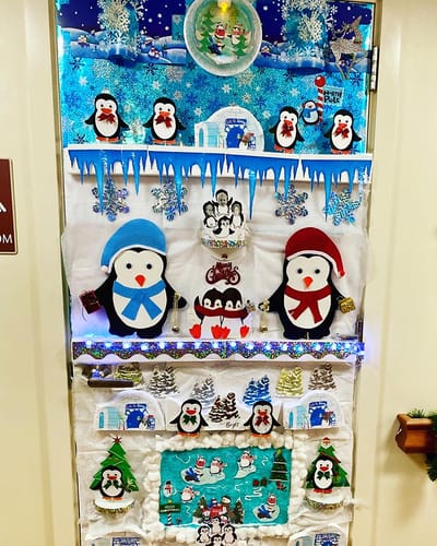 The Inn at Fairview, nursing home in Hudson, NH — Holiday-themed door decoration with penguins and snowflakes