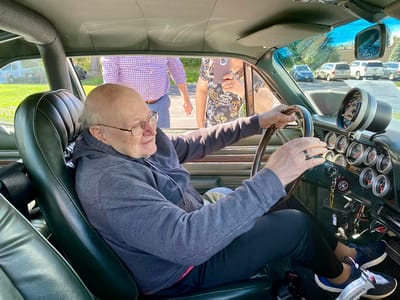 The Inn at Fairview, nursing home in Hudson, NH — Elderly man inside a classic car, smiling
