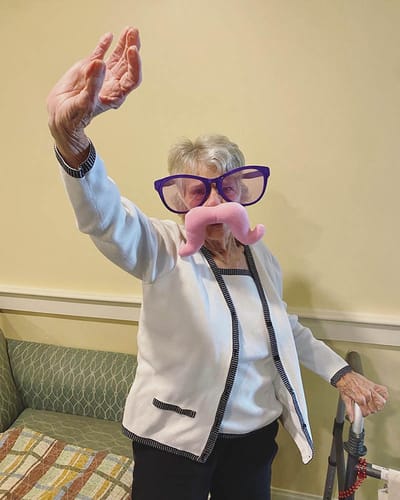 The Inn at Fairview, nursing home in Hudson, NH — Senior resident wearing oversized glasses and a novelty mustache