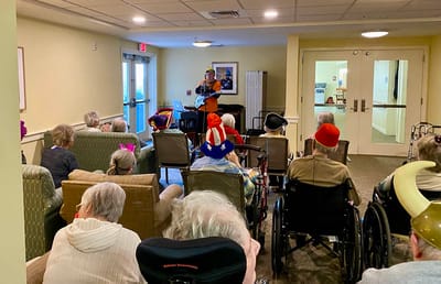 The Inn at Fairview, nursing home in Hudson, NH — Residents enjoying a musical performance in a communal lounge