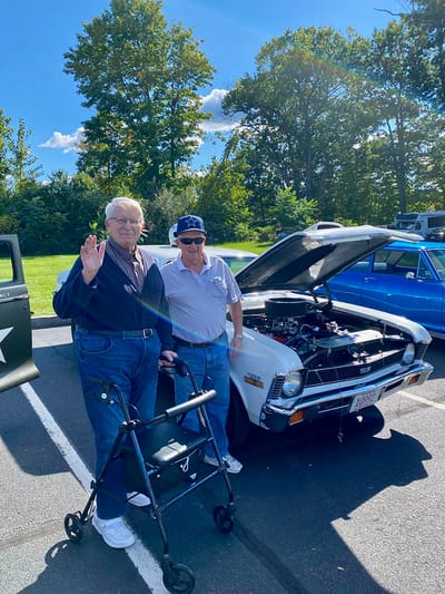 The Inn at Fairview, nursing home in Hudson, NH — Two men next to a classic car in a parking lot