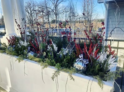 The Inn at Fairview, nursing home in Hudson, NH — Winter flower arrangement with red and white foliage