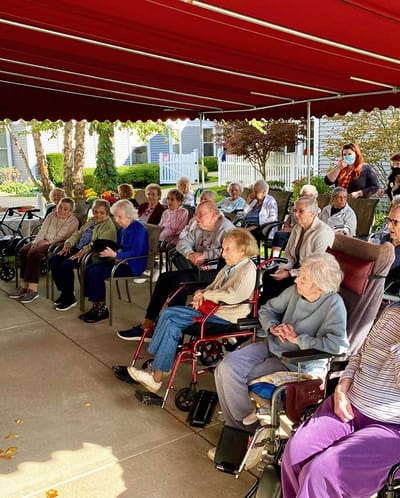 The Inn at Fairview, nursing home in Hudson, NH — Seniors gathered under a canopy for an outdoor event