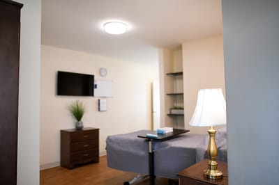 Cozy resident room with a bed and TV